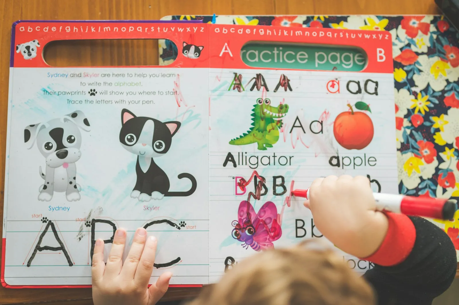 A child practising letters on an ABC worksheet